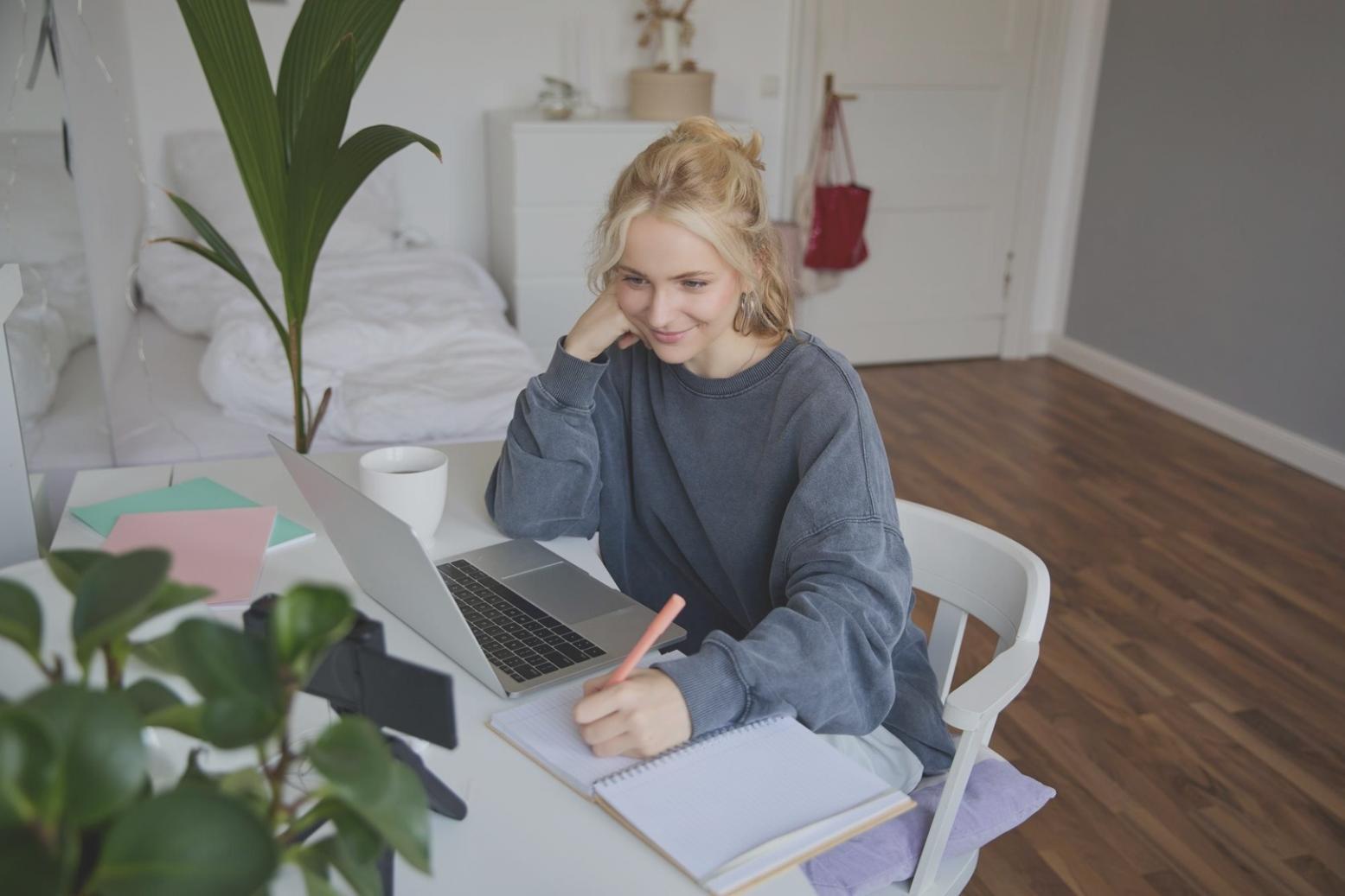 Student workspace with laptop and financial documents